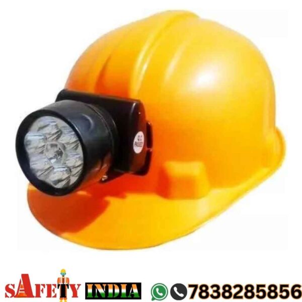 A rugged safety helmet with an integrated torch displayed on a white background, featuring a durable, protective design and a bright LED light, engineered for snake bite prevention and nighttime visibility in outdoor environments.